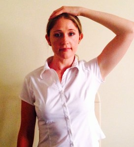 sit on one hand, place the other hand on the top of your head