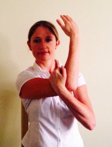 Gently pull the arm across to feel a stretch at the back of the shoulder